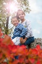 Little siblings sitting on the rock