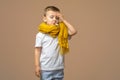 Little sick boy with Thermometer in mouth on light background.