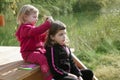 Little sister girls hairdresser on the river