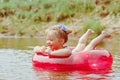 a child swims in the river in an inflatable circle Royalty Free Stock Photo