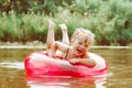 a child swims in the river in an inflatable circle Royalty Free Stock Photo