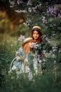 Little sisters outdoor portrait near lilac tree