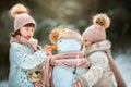 Little sisters with snowman