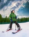 Little skier in mountain sky resort with Great sky background