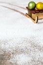 Little sledge with christmas balls on a icing sugar snow, winter