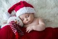 Little sleeping newborn baby boy, wearing Santa hat Royalty Free Stock Photo