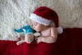 Little sleeping newborn baby boy, wearing Santa hat Royalty Free Stock Photo