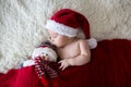 Little sleeping newborn baby boy, wearing Santa hat Royalty Free Stock Photo