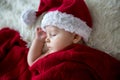 Little sleeping newborn baby boy, wearing Santa hat Royalty Free Stock Photo