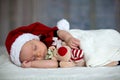 Little sleeping newborn baby boy, wearing Santa hat Royalty Free Stock Photo