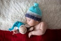 Little sleeping newborn baby boy, wearing Santa hat Royalty Free Stock Photo