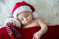 Little sleeping newborn baby boy, wearing Santa hat Royalty Free Stock Photo