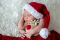 Little sleeping newborn baby boy, wearing Santa hat Royalty Free Stock Photo