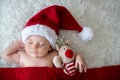 Little sleeping newborn baby boy, wearing Santa hat Royalty Free Stock Photo