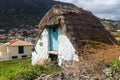 Little small, triangular, thatched-roof house santana house in the village Machico.