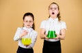 Little smart girls with testing flask. children study at biology lesson. science research in lab. knowledge and