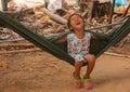 Little smiling asian girl swing in hammock