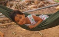 Little smiling asian girl swing in hammock