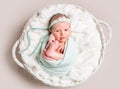 Little smiling baby in basket, top view