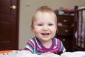 Little smiling baby girl standing near the bed Royalty Free Stock Photo