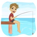 Little smiling boy fishing on lake sitting on a wood pontoon in the morning Royalty Free Stock Photo