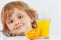 Little smiling boy with a glass of fresh juice and orange Royalty Free Stock Photo