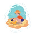 Little smiling boy playing with a bucket and shovel sitting in the sand near the water Royalty Free Stock Photo