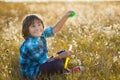 Little smiling boy playing soap bubbles in summer park outdoor Royalty Free Stock Photo