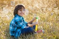 Little smiling boy playing soap bubbles in summer park outdoor Royalty Free Stock Photo