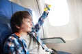 Little smiling boy with toy plane by the window Royalty Free Stock Photo