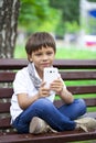 Little smiling child boy hand holding mobile phone or smartphone Royalty Free Stock Photo