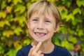 Little smiling child boy hand pointing his first baby milk or temporary tooth fall out Royalty Free Stock Photo