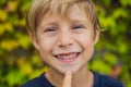 Little smiling child boy hand pointing his first baby milk or temporary tooth fall out Royalty Free Stock Photo