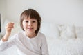 Little smiling child boy hand pointing his first baby milk tooth Royalty Free Stock Photo