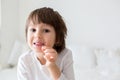 Little smiling child boy hand pointing his first baby milk tooth Royalty Free Stock Photo