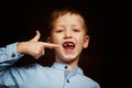 Little smiling child, boy hand showing his first milk or temporary teeth fall out. Royalty Free Stock Photo