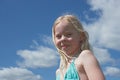 Little smiling girl against sky in summer Royalty Free Stock Photo