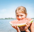 Little smiling Girl eating red watermelon portrait on the beach Royalty Free Stock Photo