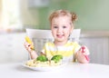 Little smiling girl eating vegetables,healthy food concept Royalty Free Stock Photo