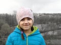 little smiling girl on a gray landscape