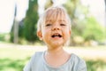 Little smiling girl on a green lawn. Portrait Royalty Free Stock Photo