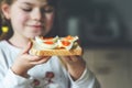 Little smiling girl have a breakfast at home. Preschool child eating sandwich with boiled eggs. Happy children, healthy Royalty Free Stock Photo