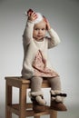 Little smiling girl is holding her christmas hat on head Royalty Free Stock Photo