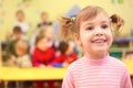 Little smiling girl in kindergarten