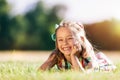 Little smiling girl laying on the grass field in the park. Royalty Free Stock Photo