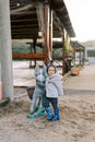 Little smiling girl leaned against the pack donkey statue