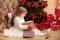 Little smiling girl opens a magic Christmas gift box Royalty Free Stock Photo