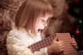 Little smiling girl opens a magic Christmas gift box Royalty Free Stock Photo