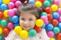 .Little smiling girl playing lying in ball park. Close-up, portrait Royalty Free Stock Photo