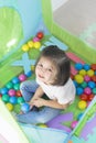 Little smiling girl playing lying in ball park. Close up, portrait Royalty Free Stock Photo